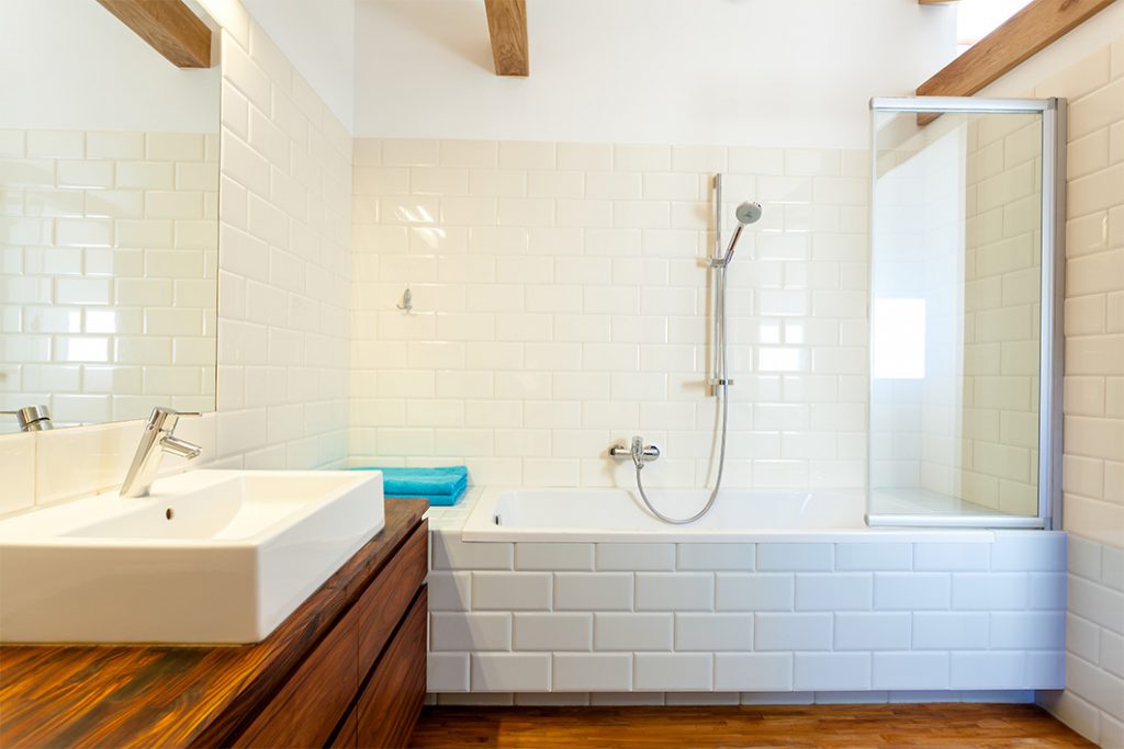 Bathroom Remodeling in Bucks County PA- A bathroom with white tile and wood floors.