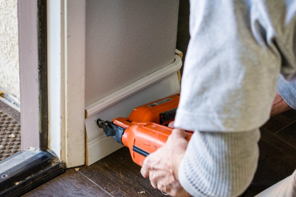 Bathroom Remodeling in Bucks County PA- A person using an electric drill to install the door.